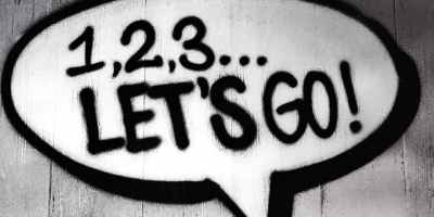 spray painted speech bubble containing the message "1, 2, 3... Let's Go!"