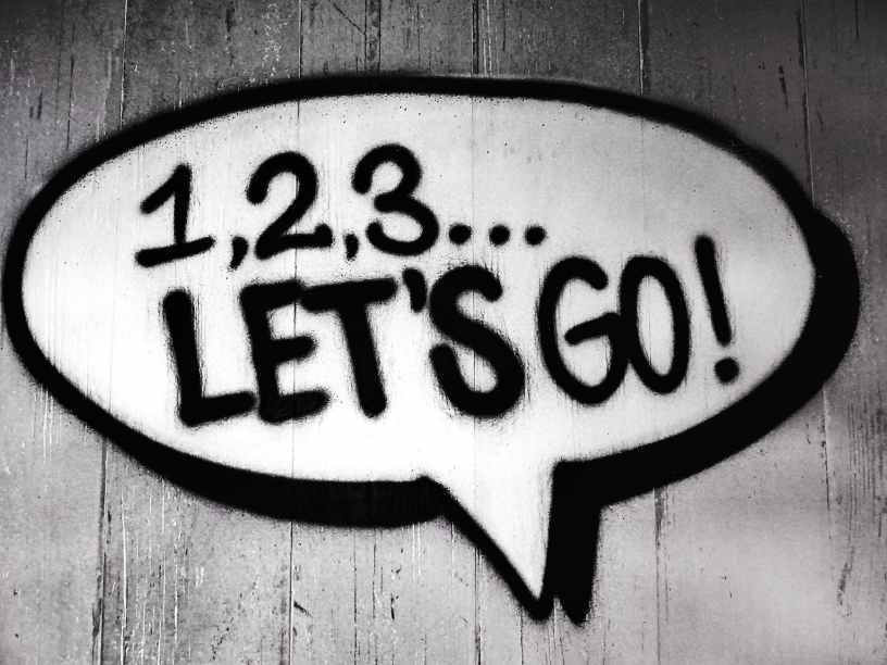 spray painted speech bubble containing the message "1, 2, 3... Let's Go!"